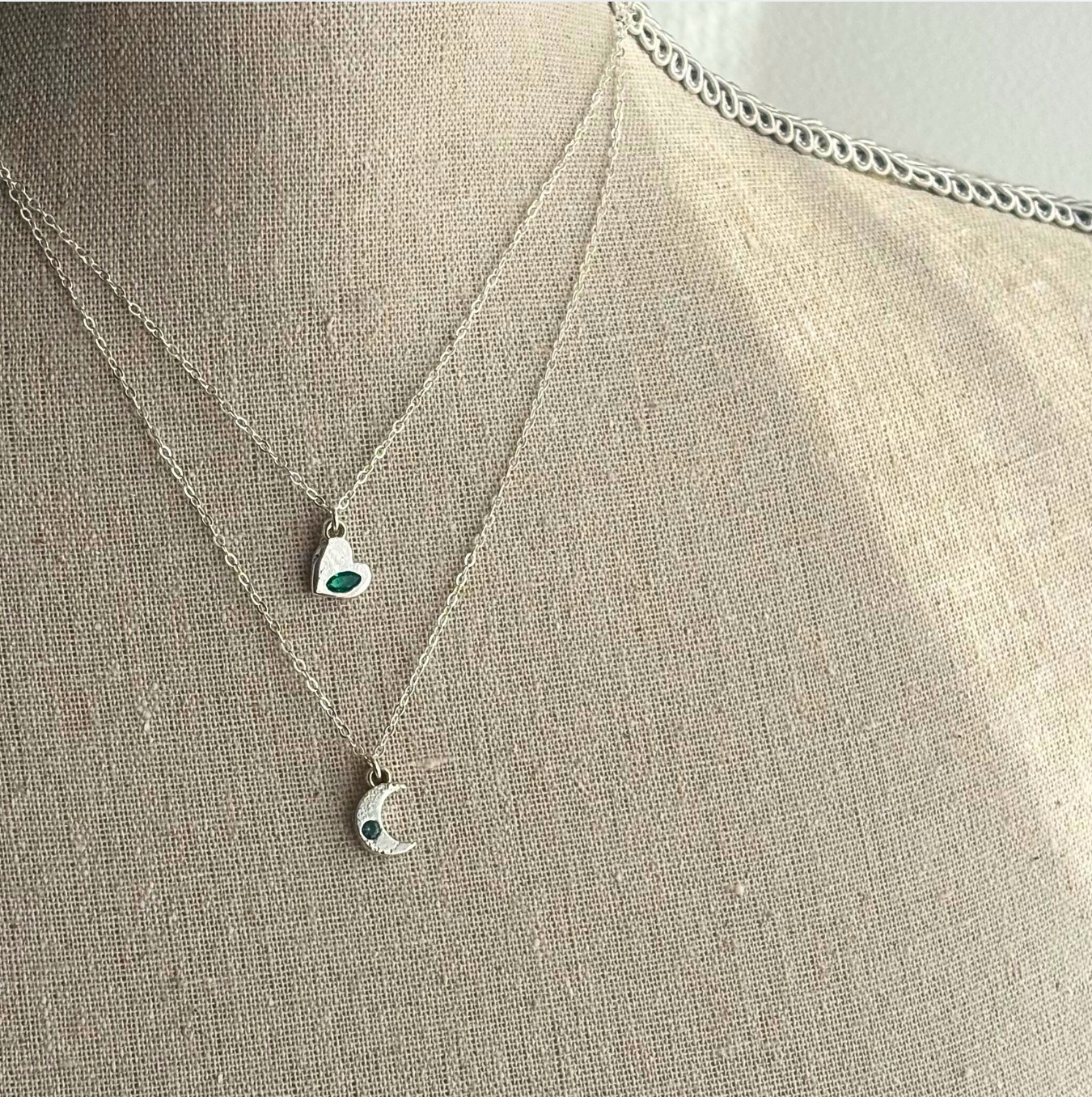 Necklace with pendant on a mannequin bust against a neutral background