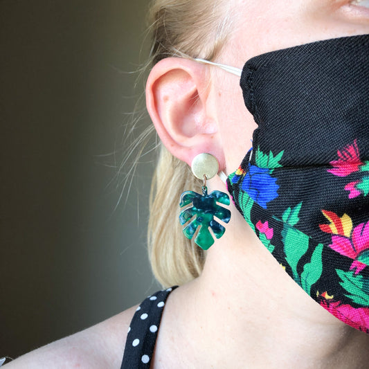 strut jewelry mask with lucite monstera leaf earrings
