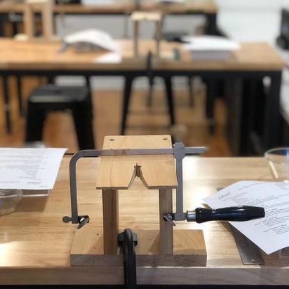 A jeweller's saw on a bench pin in a studio.