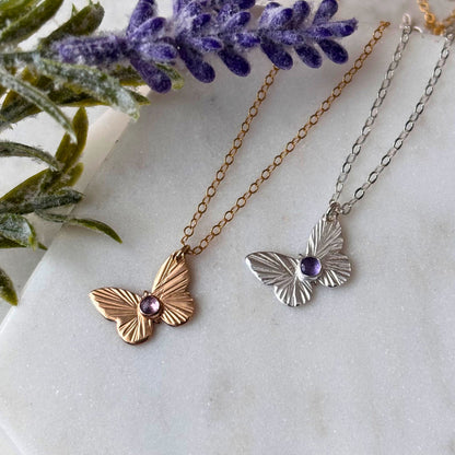 Two butterfly necklaces, one with a gold-filled chain and butterfly, and the other in silver