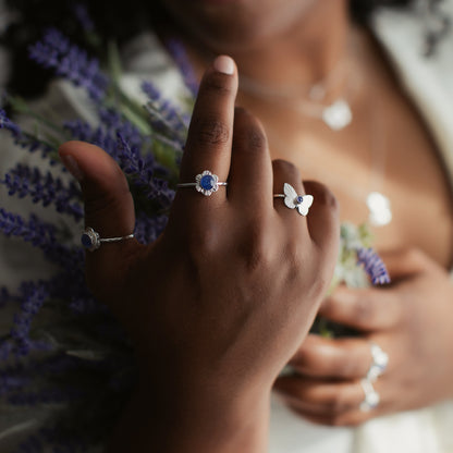 A woman holding flowers showing a flower ring on her pointer finger.