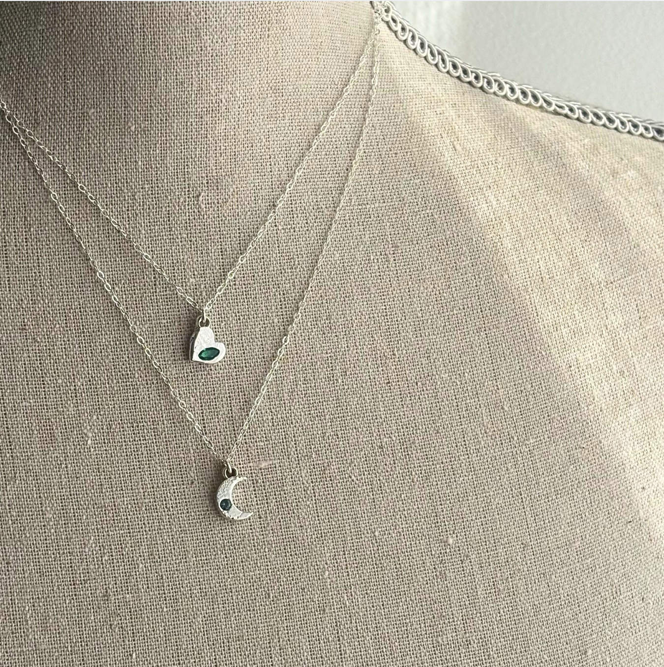 Necklace with pendant on a mannequin bust against a neutral background