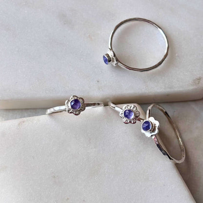 Silver petite flower rings with tanzanite gemstones.