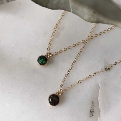 Two petite black opal necklaces displayed on a white surface.